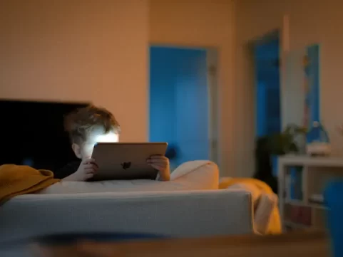 Child on tablet in dark room